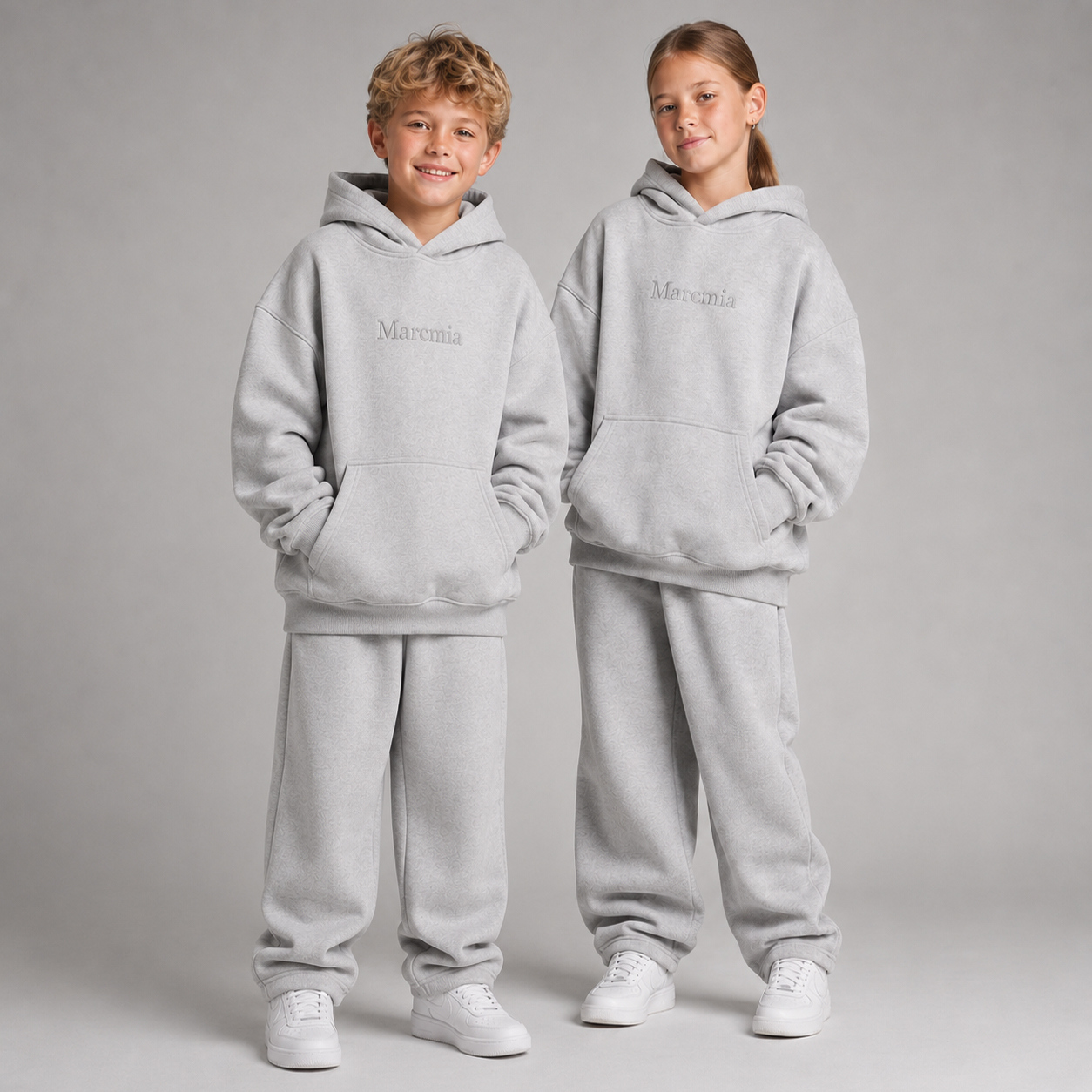 Two children wearing heather grey Marcmia hoodie sets